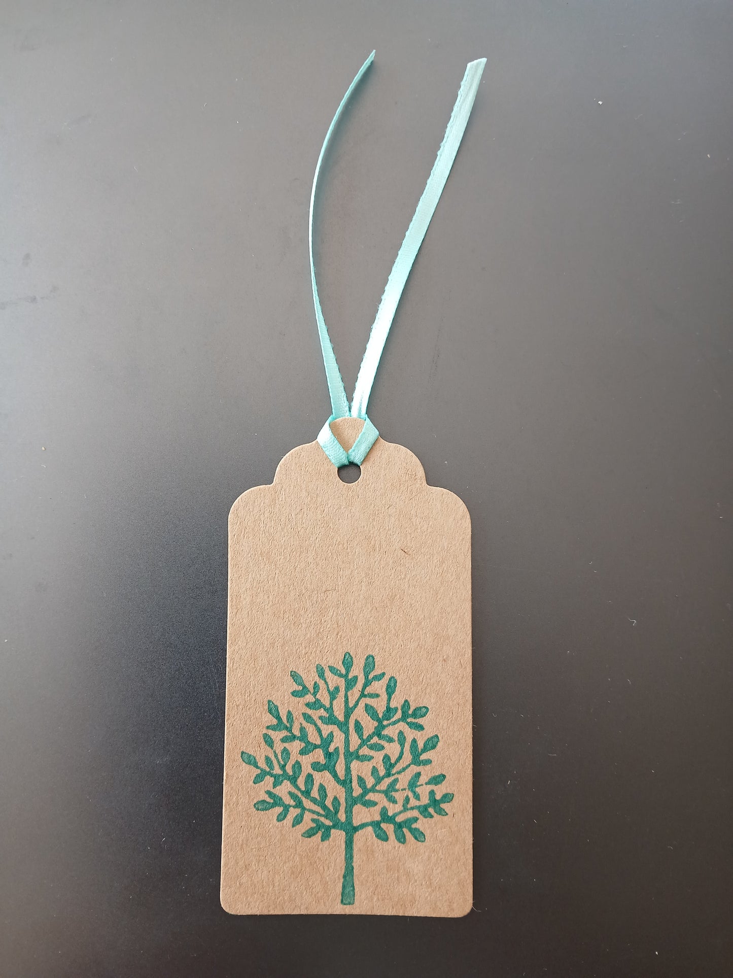 Indian Tree in Teal on oblong brown gift tag with ribbon