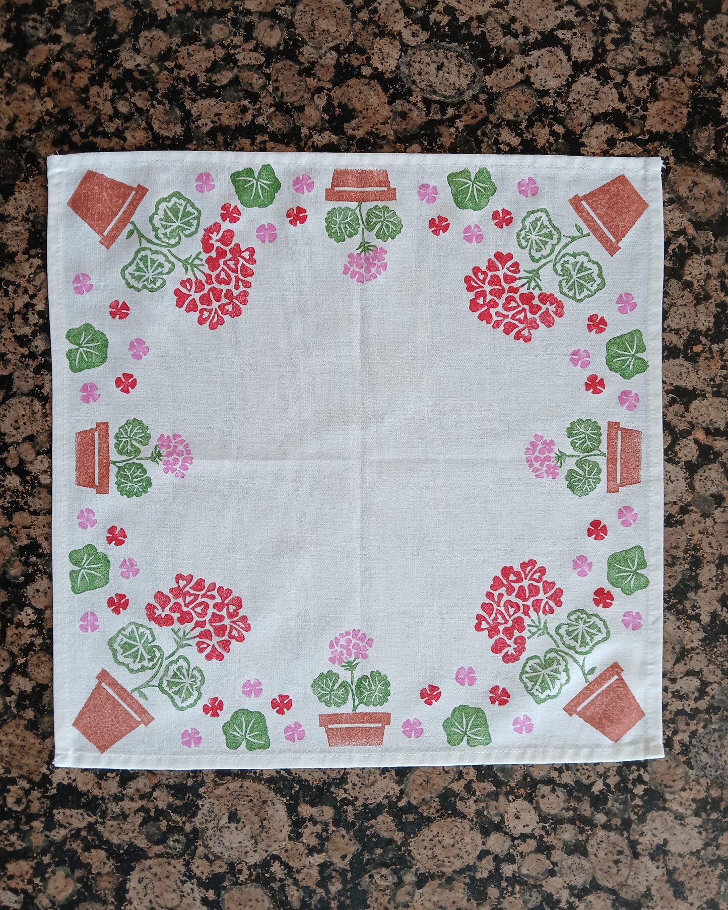 Geraniums in Red, Pink, Greens & Brown on white cotton napkin
