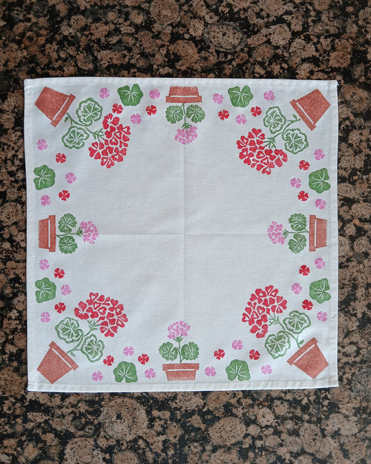 Geraniums in Red, Pink, Greens & Brown on white cotton napkin