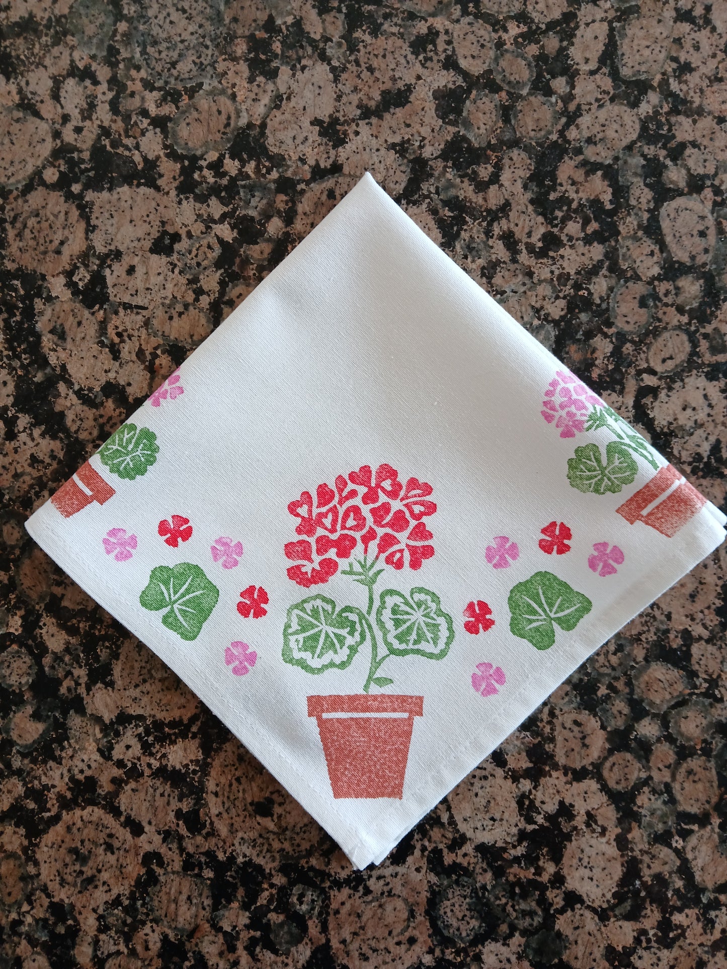 Geraniums in Red, Pink, Greens & Brown on white cotton napkin