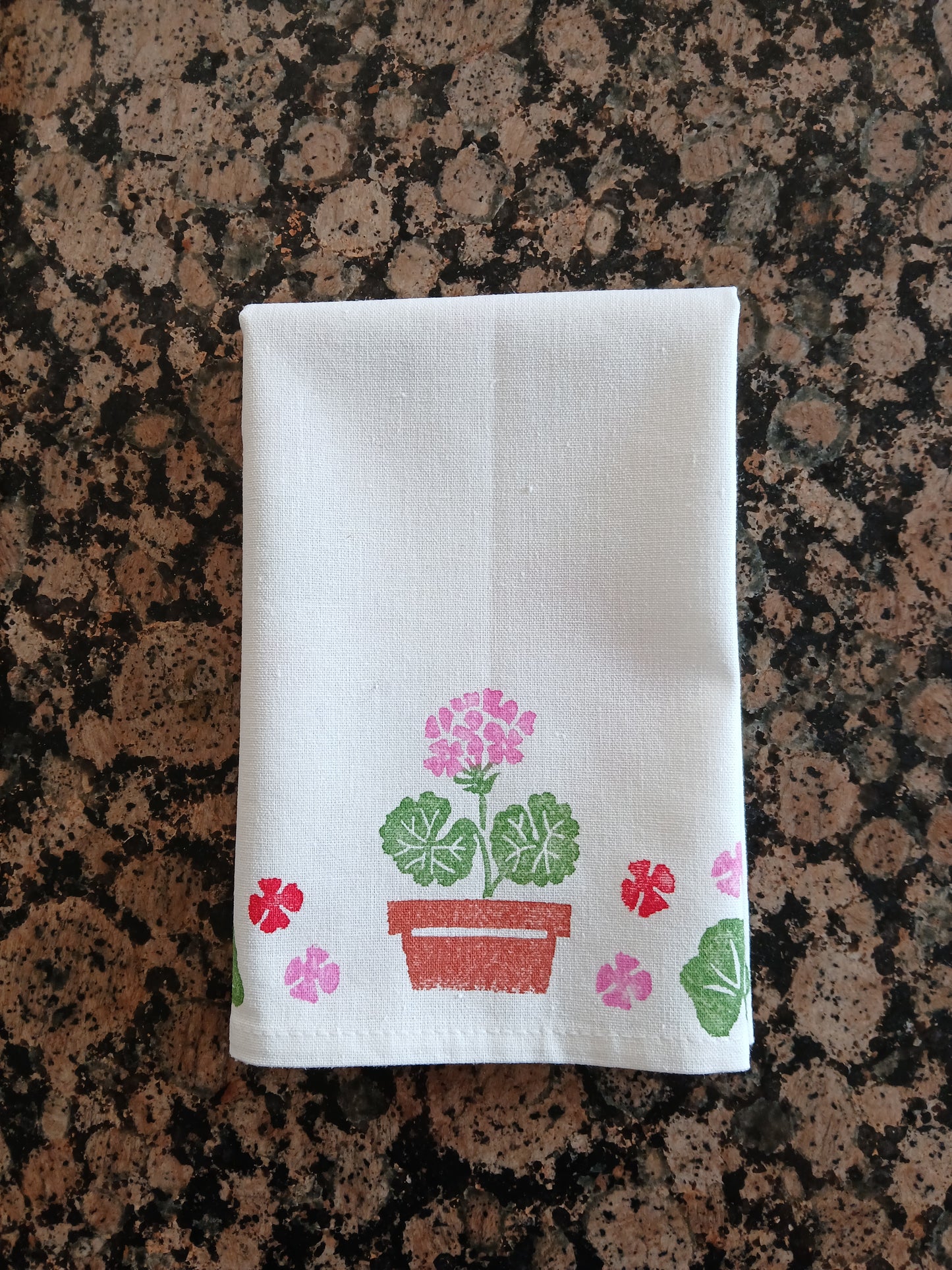 Geraniums in Red, Pink, Greens & Brown on white cotton napkin