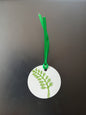 Indian Curved Leaf in Green on round white gift tag with ribbon