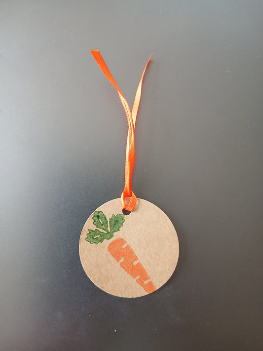 Carrot in Orange & Green on round brown gift tag with ribbon