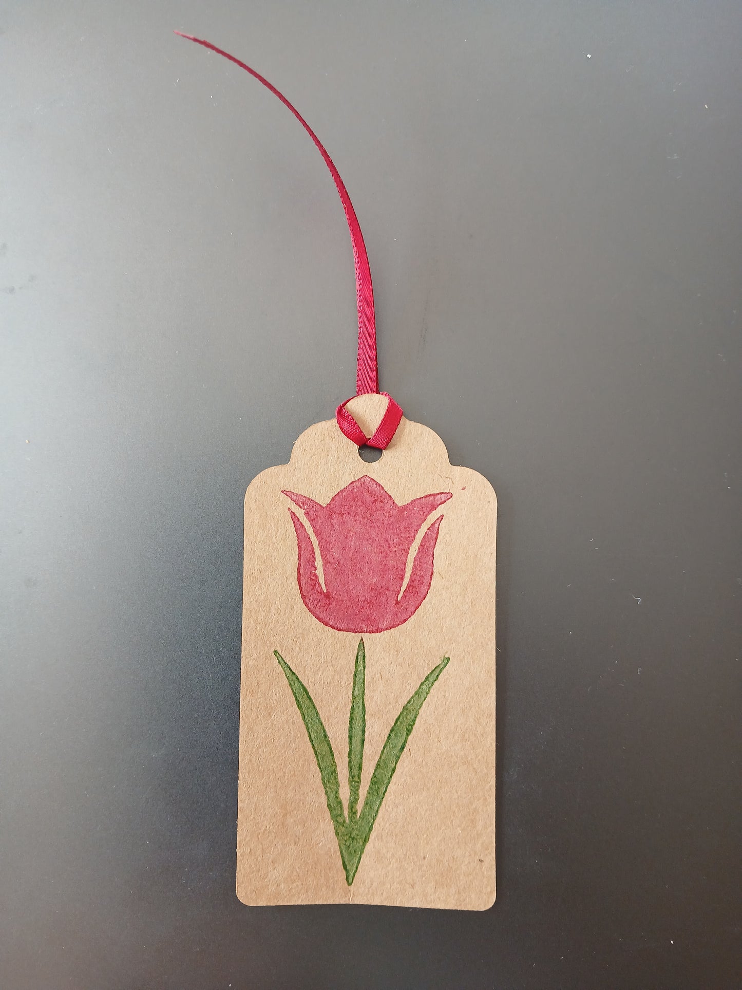 Tulip in Raspberry & Green on oblong brown gift tag with ribbon