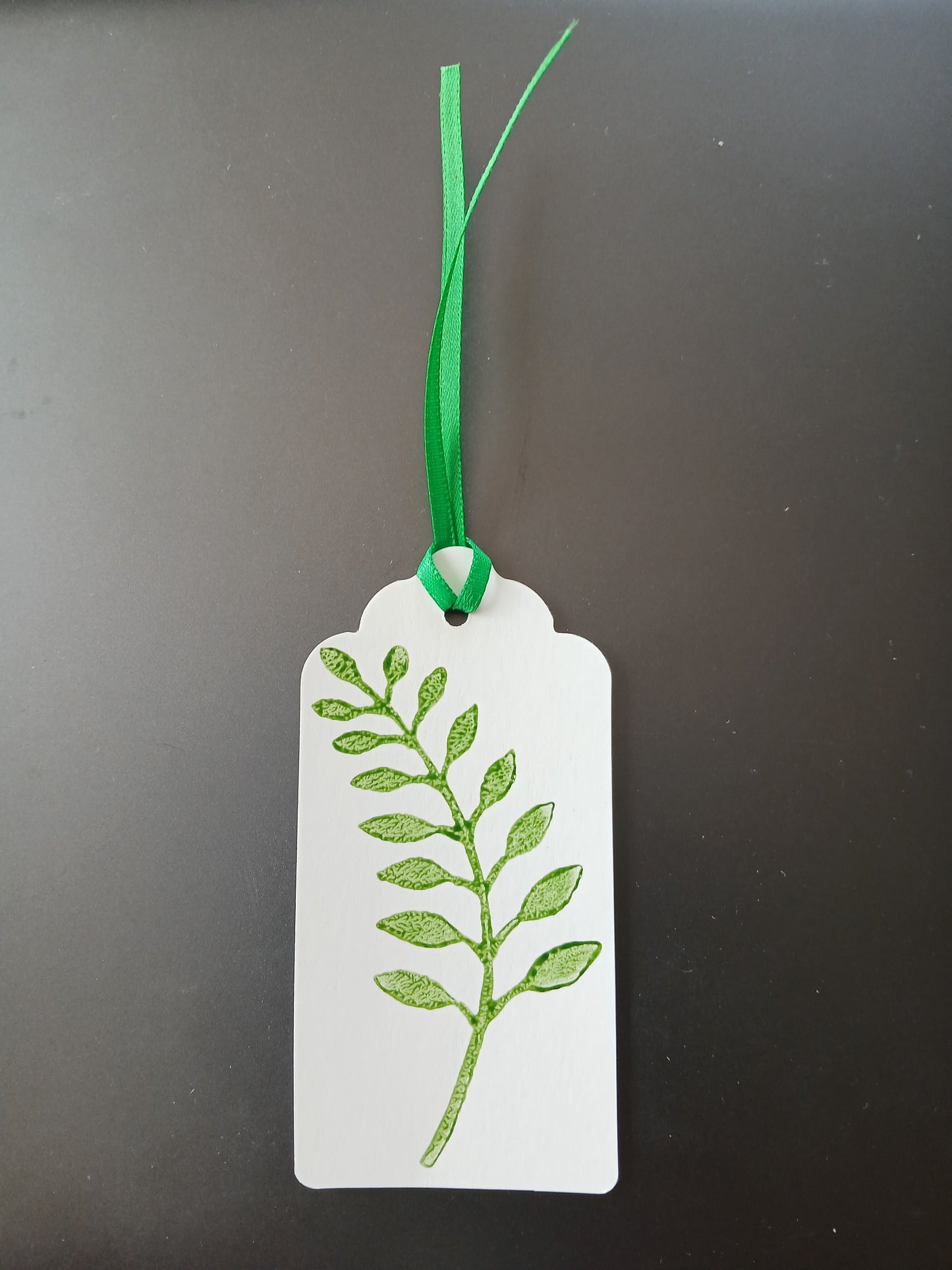 Indian Curved Leaf in Green on oblong white gift tag with ribbon