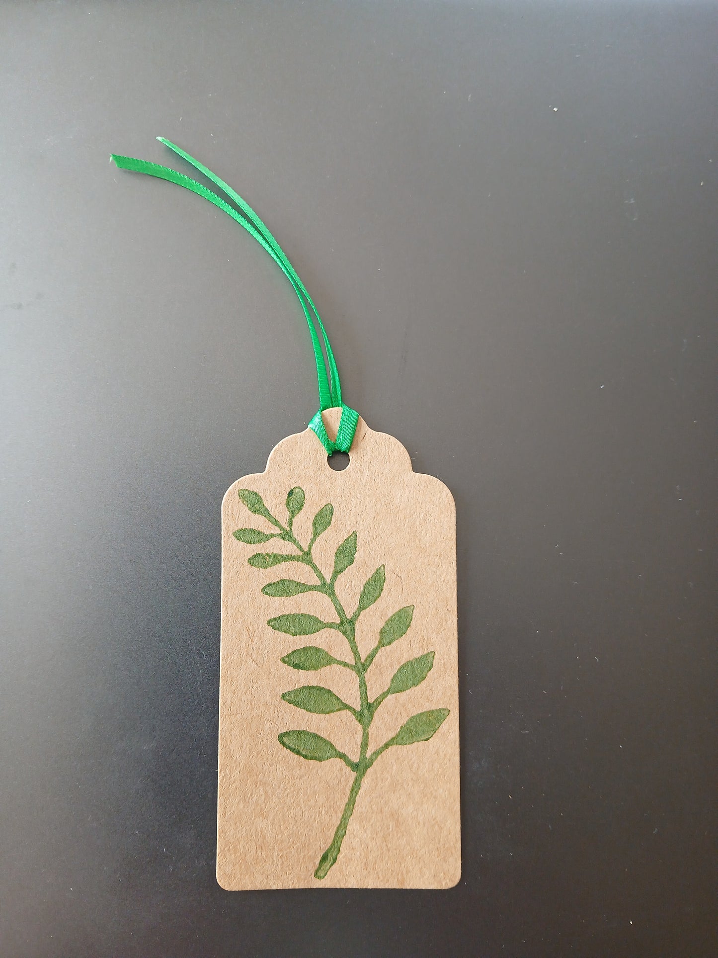 Indian Curved Leaf in Green on oblong brown gift tag with ribbon