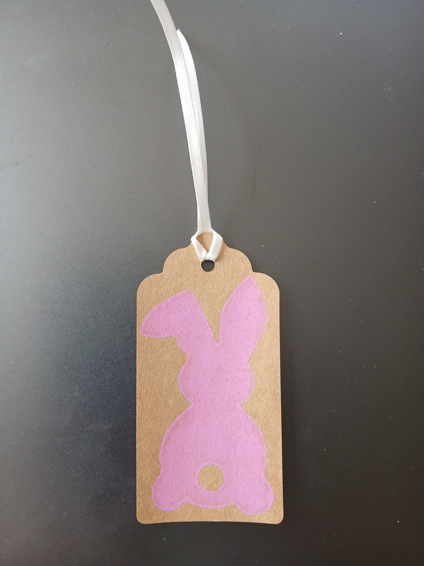 Bunny (large) in Pink on oblong brown gift tag with ribbon