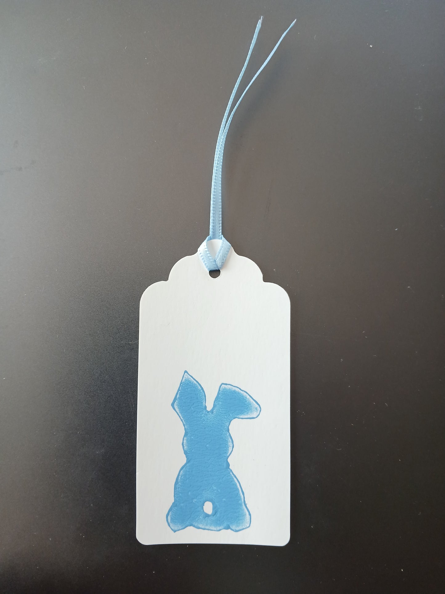 Bunny (small) in Blue on oblong white gift tag with ribbon