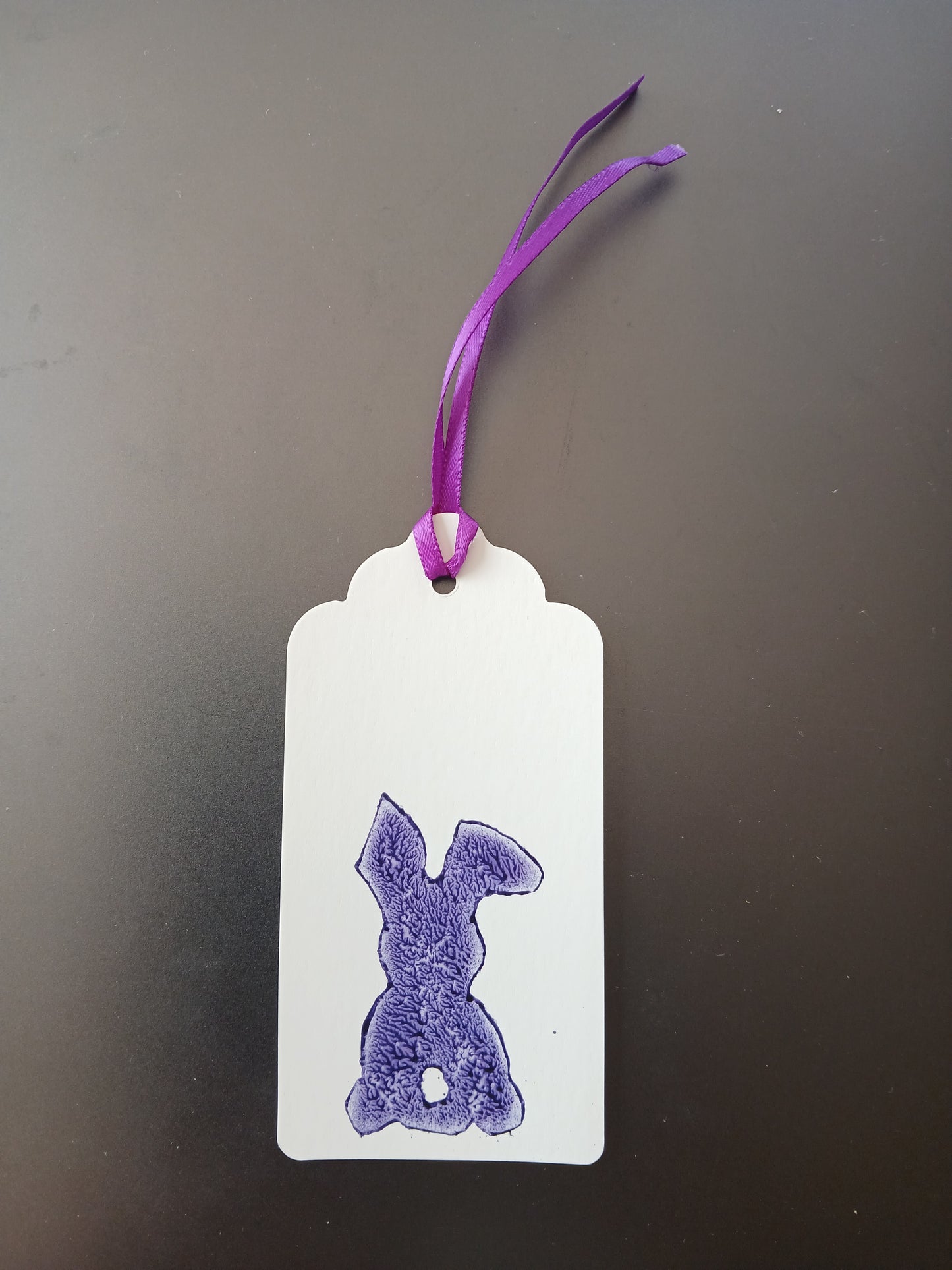 Bunny (small) in Purple on oblong white gift tag with ribbon