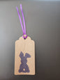 Bunny (small) in Purple on oblong brown gift tag with ribbon