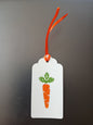 Carrot in Orange & Green on oblong white gift tag with ribbon
