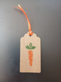 Carrot in Orange & Green on oblong brown gift tag with ribbon