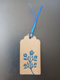 Flower Bunch in Brilliant Blue on oblong brown gift tag with ribbon