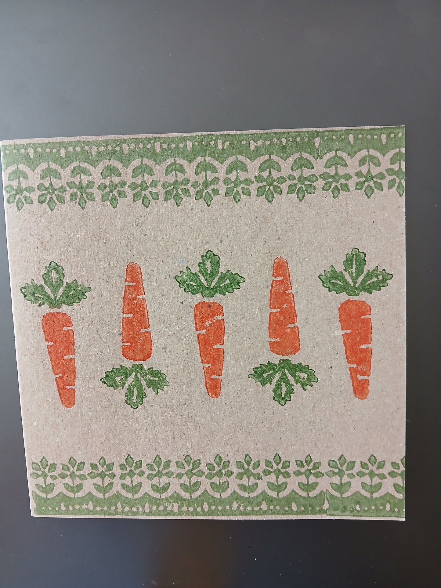 Carrots with floral border in Orange & Green on brown card