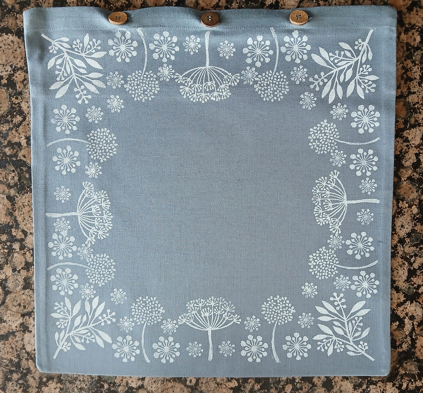 Seeds in White on dusky blue/grey cushion cover with buttons