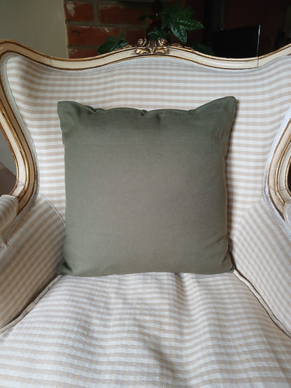 Ferns in White on olive green cushion cover with buttons