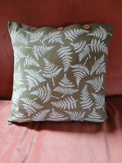 Ferns in White on olive green cushion cover with buttons