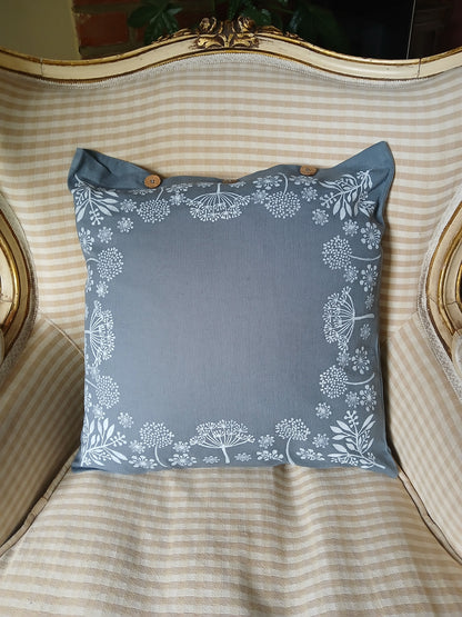 Seeds in White on dusky blue/grey cushion cover with buttons