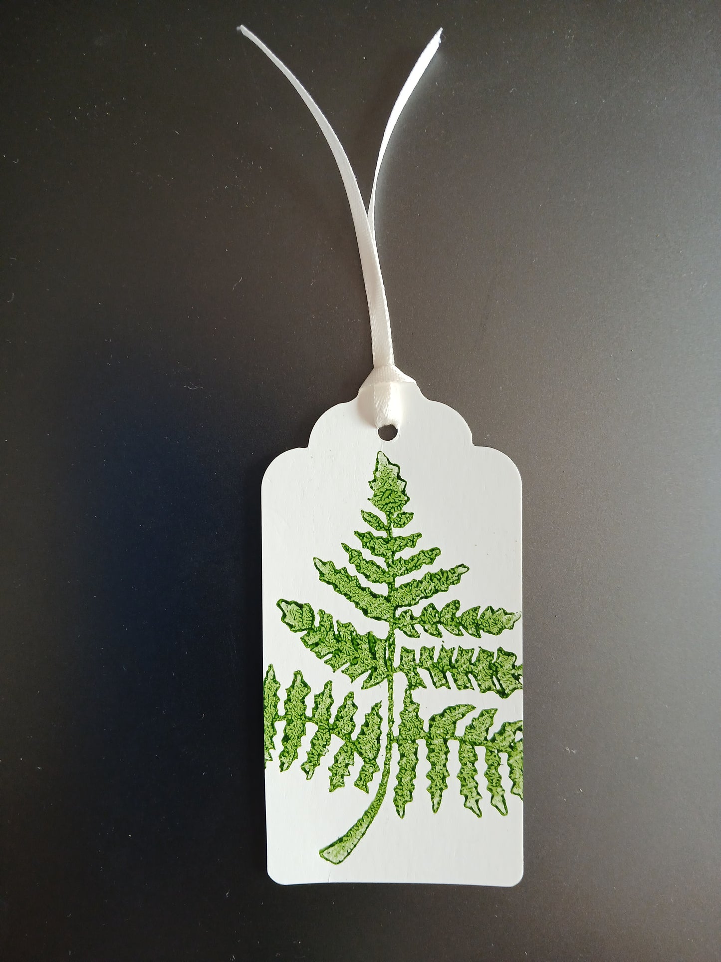 Fern 1 in Dark Green on oblong white gift tag with ribbon