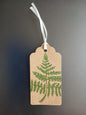 Fern 1 in Dark Green on oblong brown gift tag with ribbon