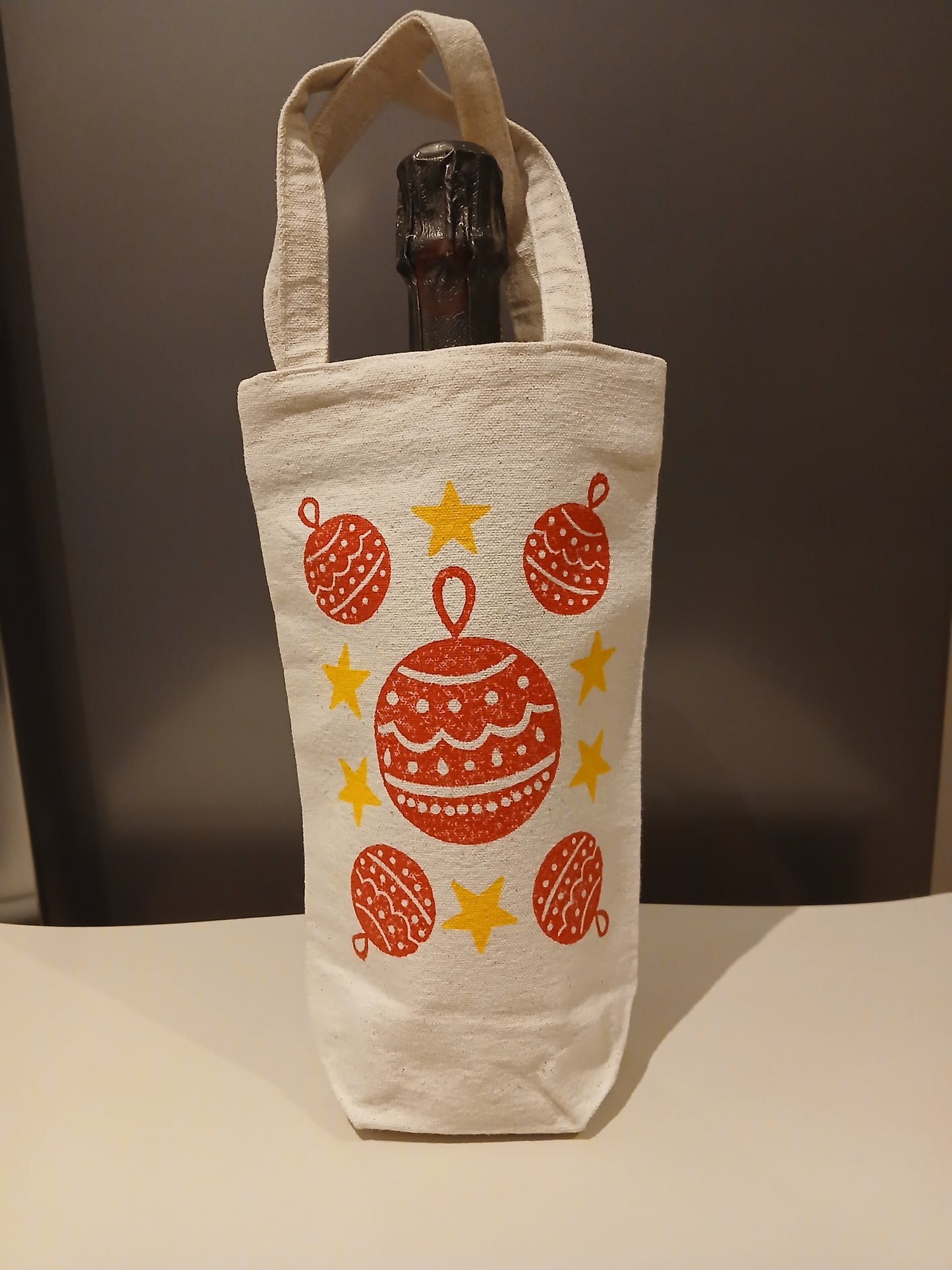 Christmas Baubles & Stars in red & yellow on natural cotton canvas bottle bag
