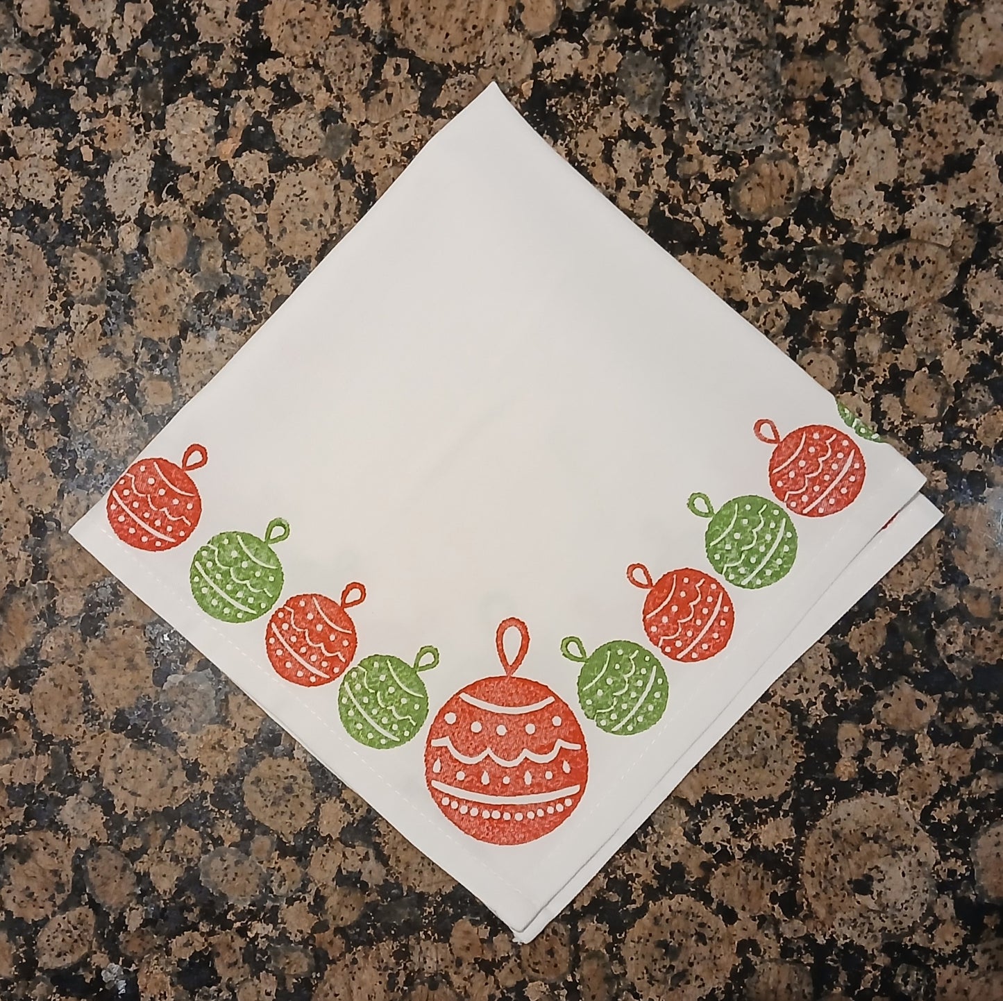 Christmas Baubles in red & green on white cotton napkin
