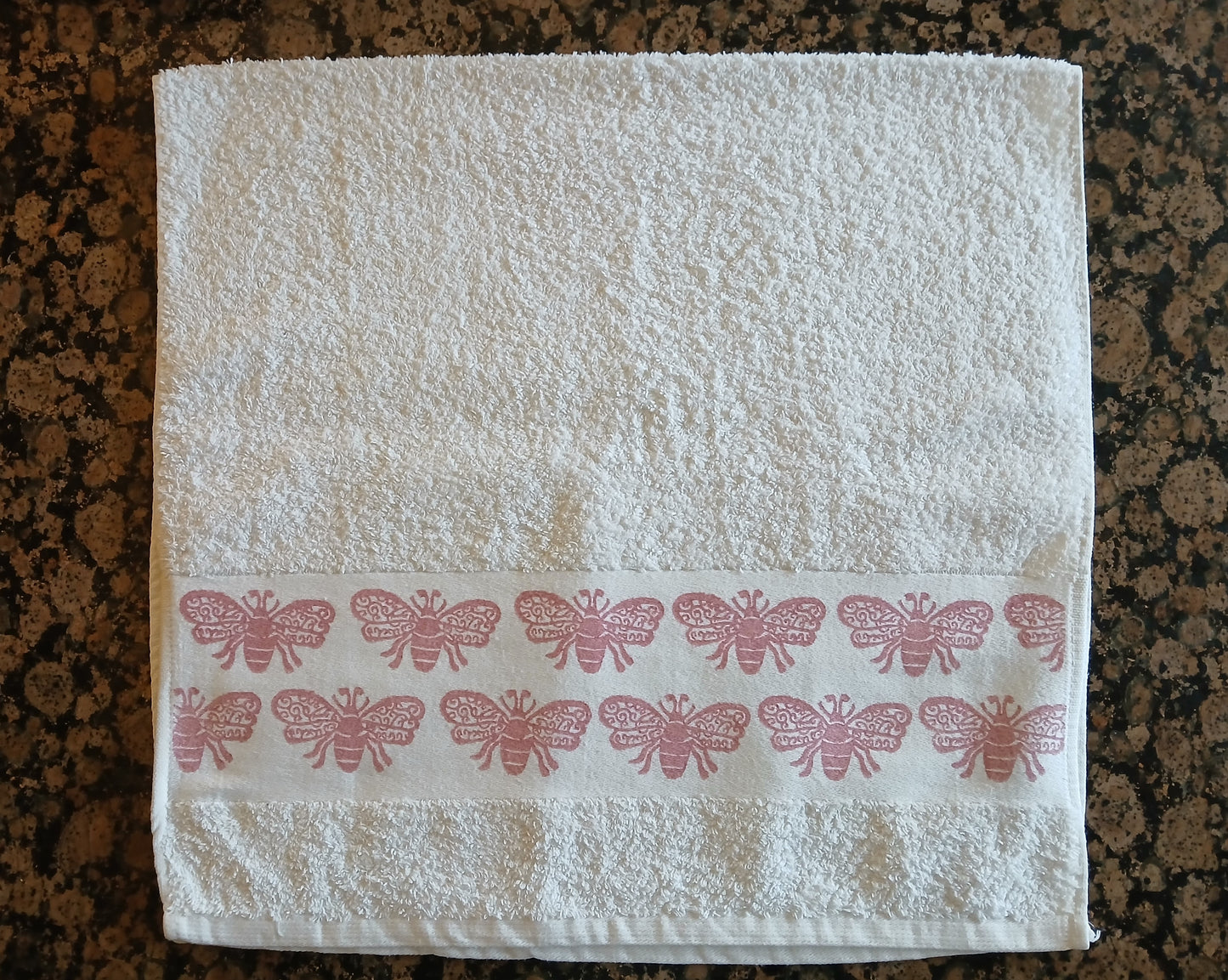 Bees in rose pink on cotton hand towel