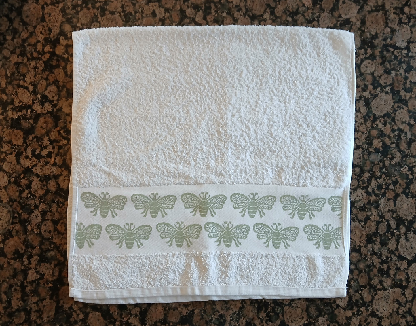Bees in pale green on cotton hand towel