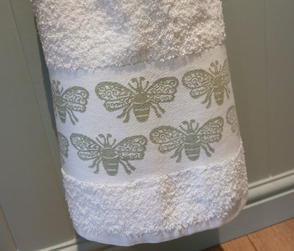 Bees in pale green on cotton hand towel
