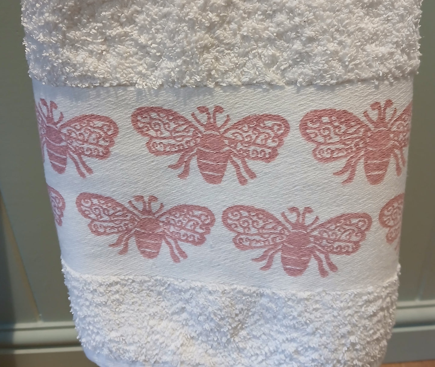 Bees in rose pink on cotton hand towel
